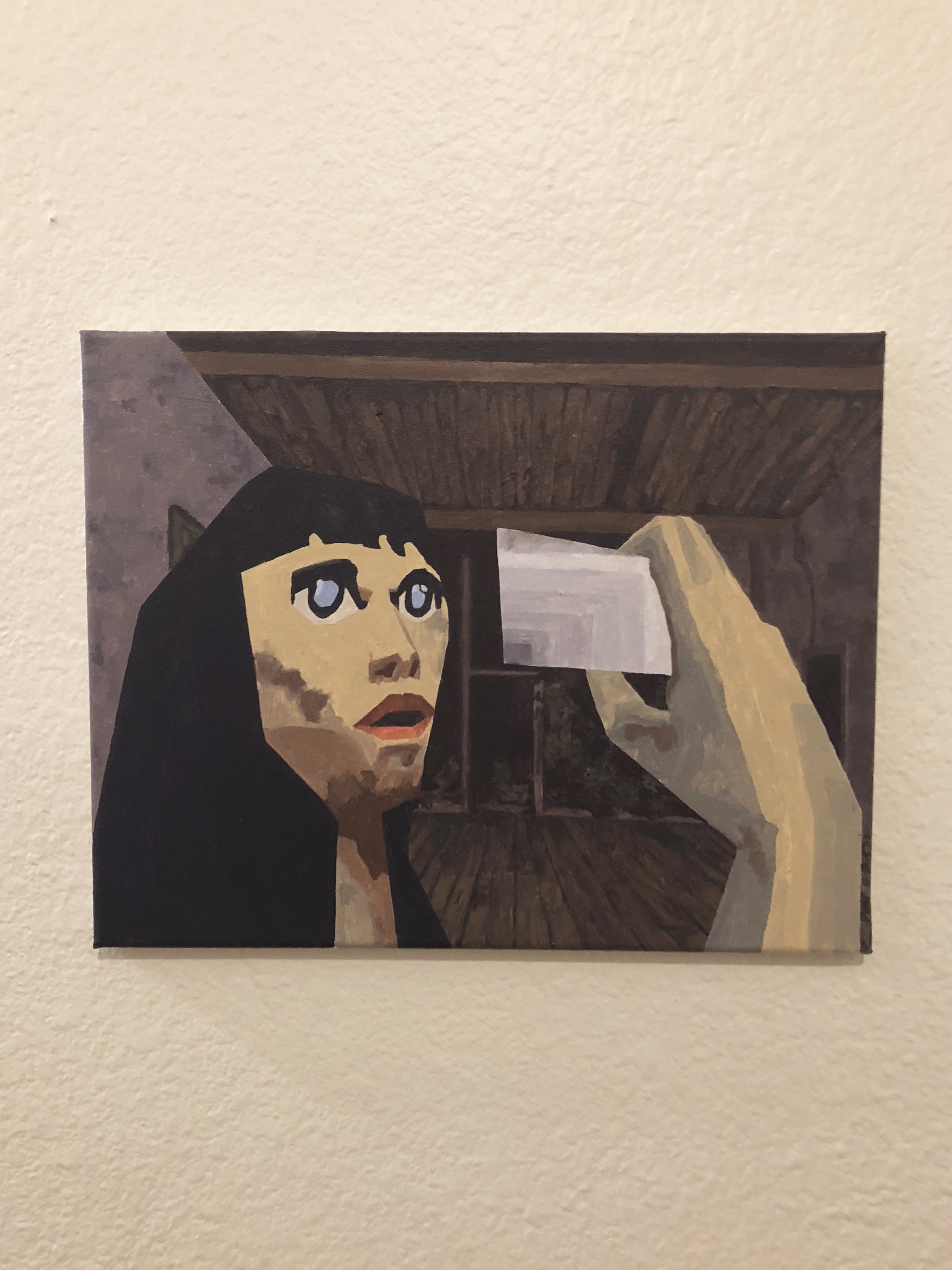Painting of a stylized female figure hung on a white wall